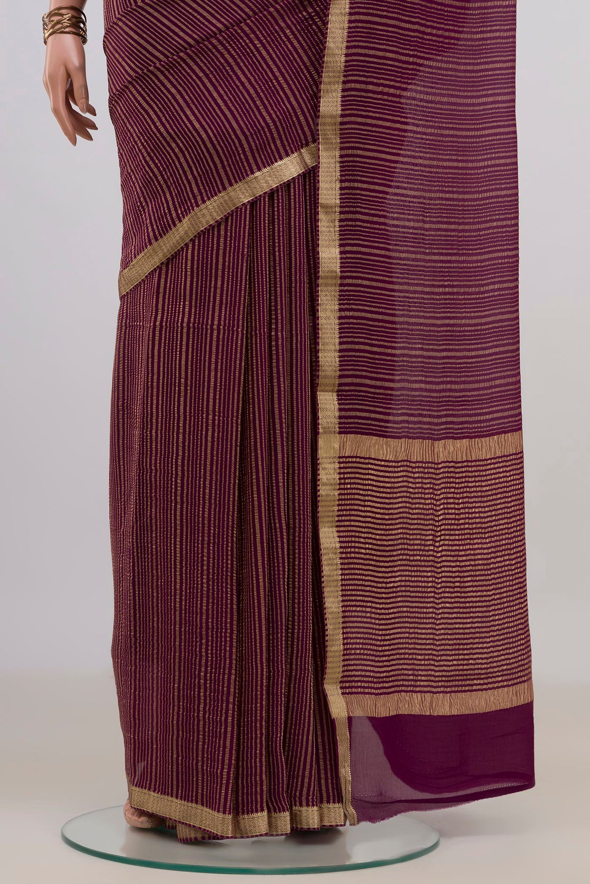 Pleats and pallu of Magenta Mysore Georgette Saree with Stripes on the body and Thin Zari Line. 