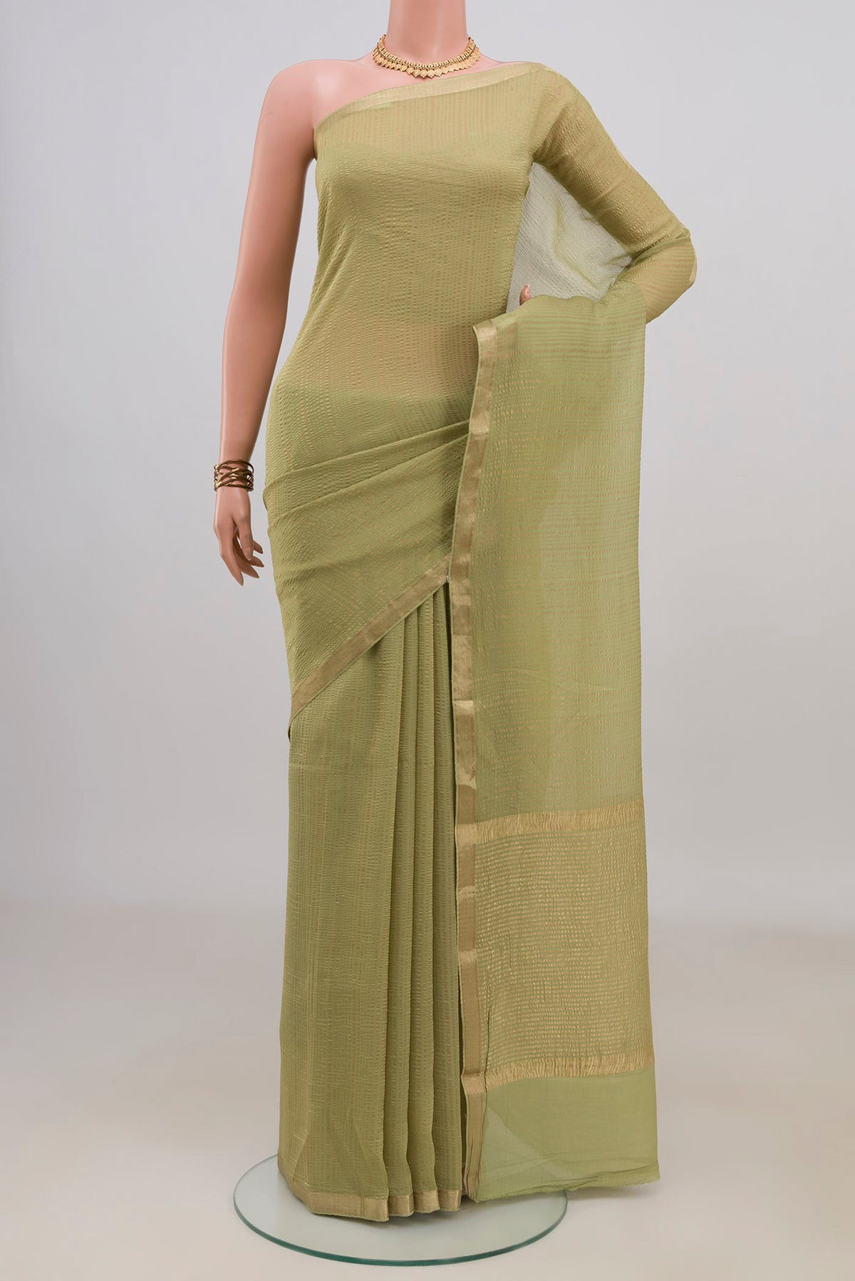 Light Green Mysore Georgette Saree with Stripes on the body and Thin Zari Line.  displayed on a mannequin