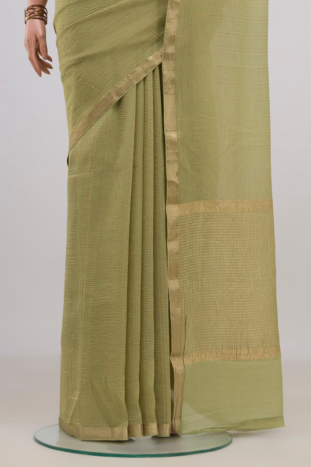 Pleats and pallu of Light Green Mysore Georgette Saree with Stripes on the body and Thin Zari Line. 