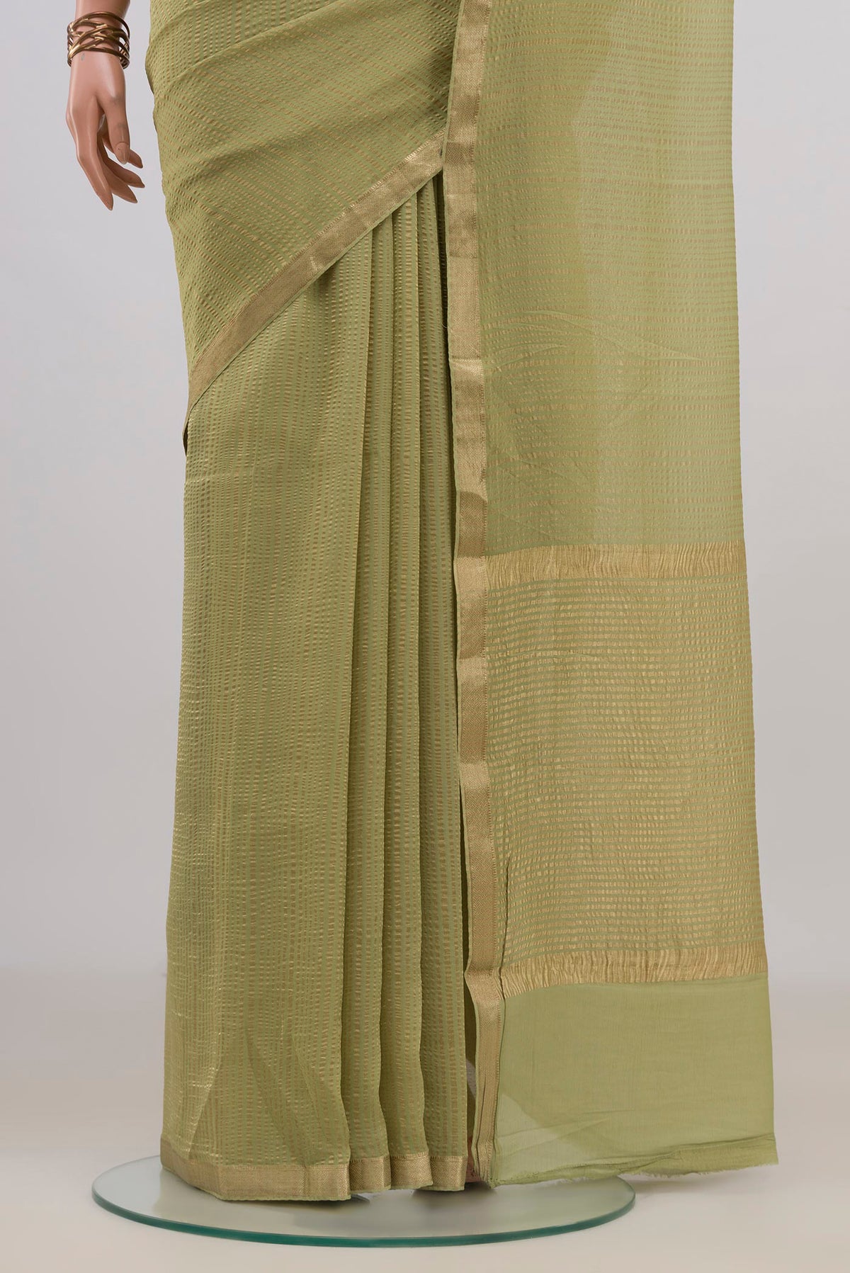 Pleats and pallu of Light Green Mysore Georgette Saree with Stripes on the body and Thin Zari Line. 