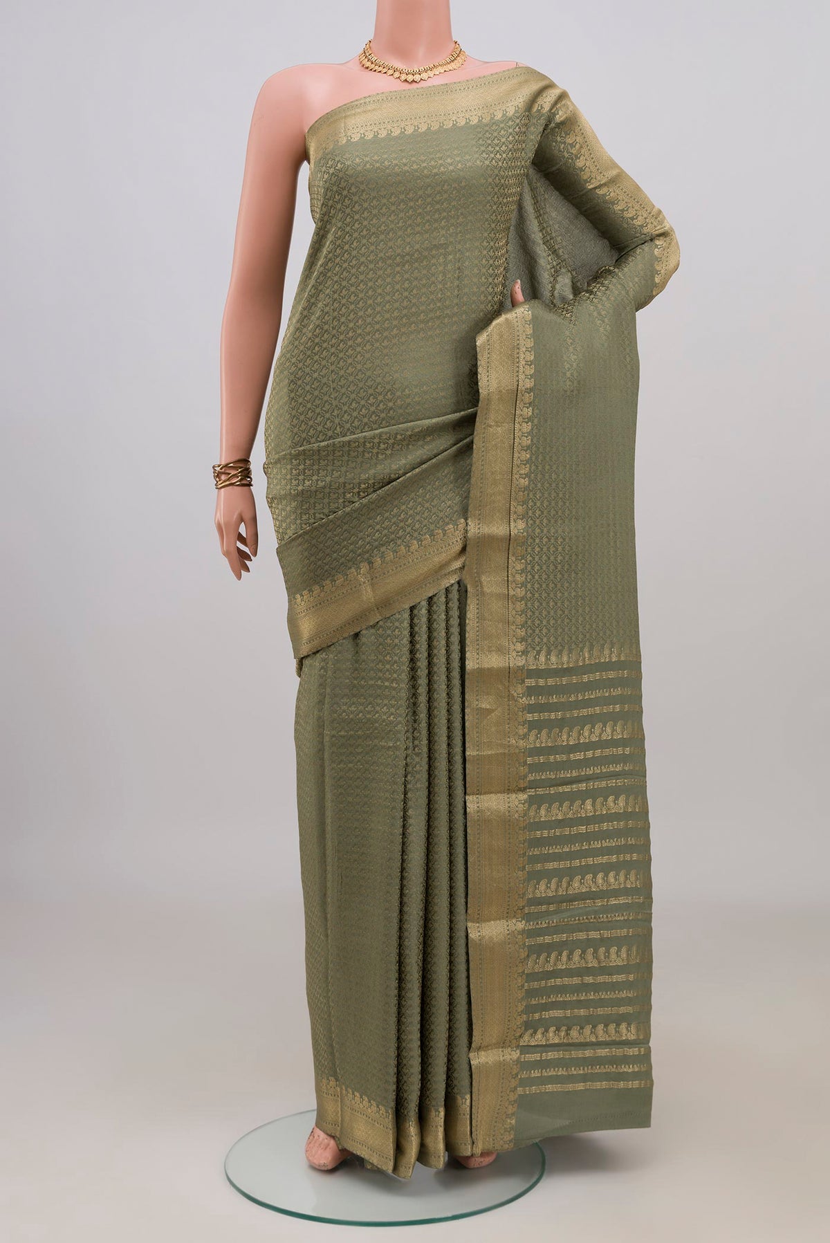 Sage Green Mysore Crepe Saree with Zari Brocade on the body and Zari Border.  displayed on a mannequin