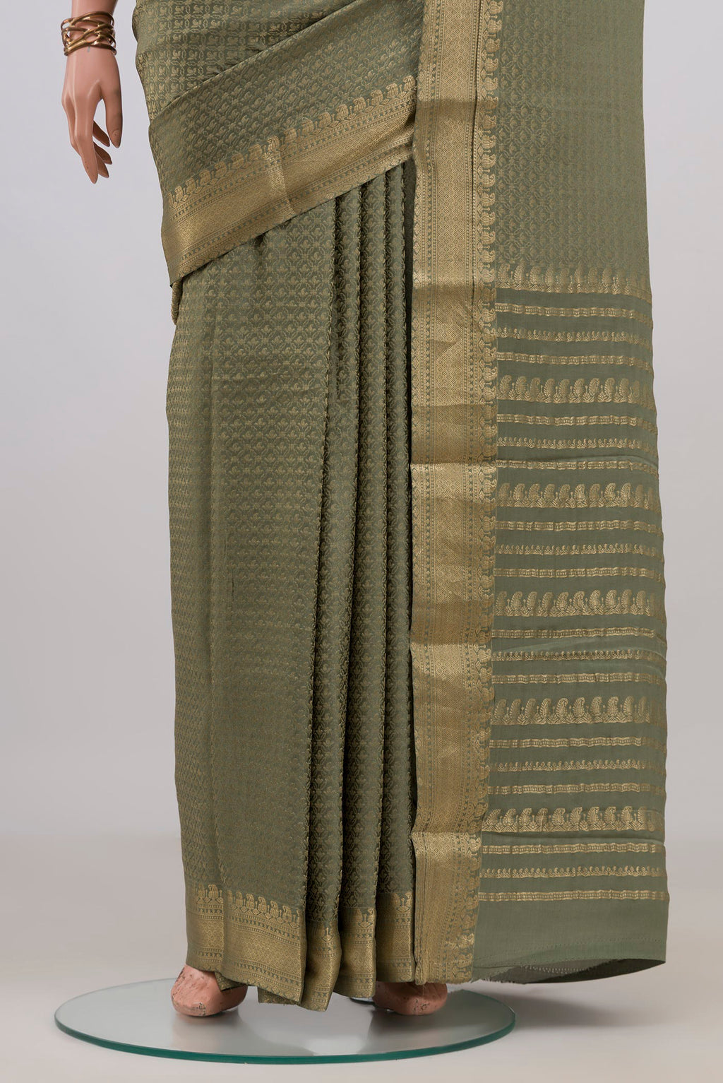 Pleats and pallu of Sage Green Mysore Crepe Saree with Zari Brocade on the body and Zari Border. 