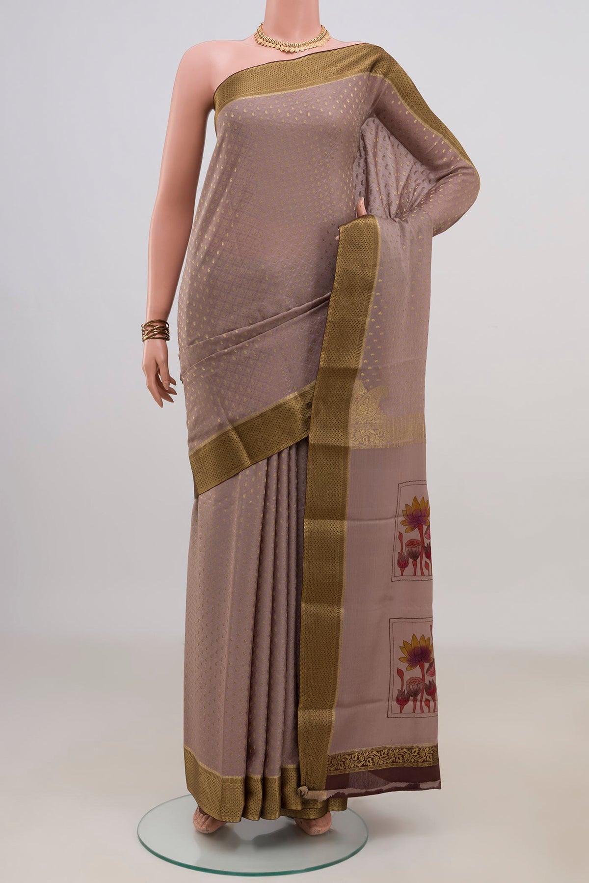 Grey Crepe Saree with Fancy on the body and Zari Border.  displayed on a mannequin