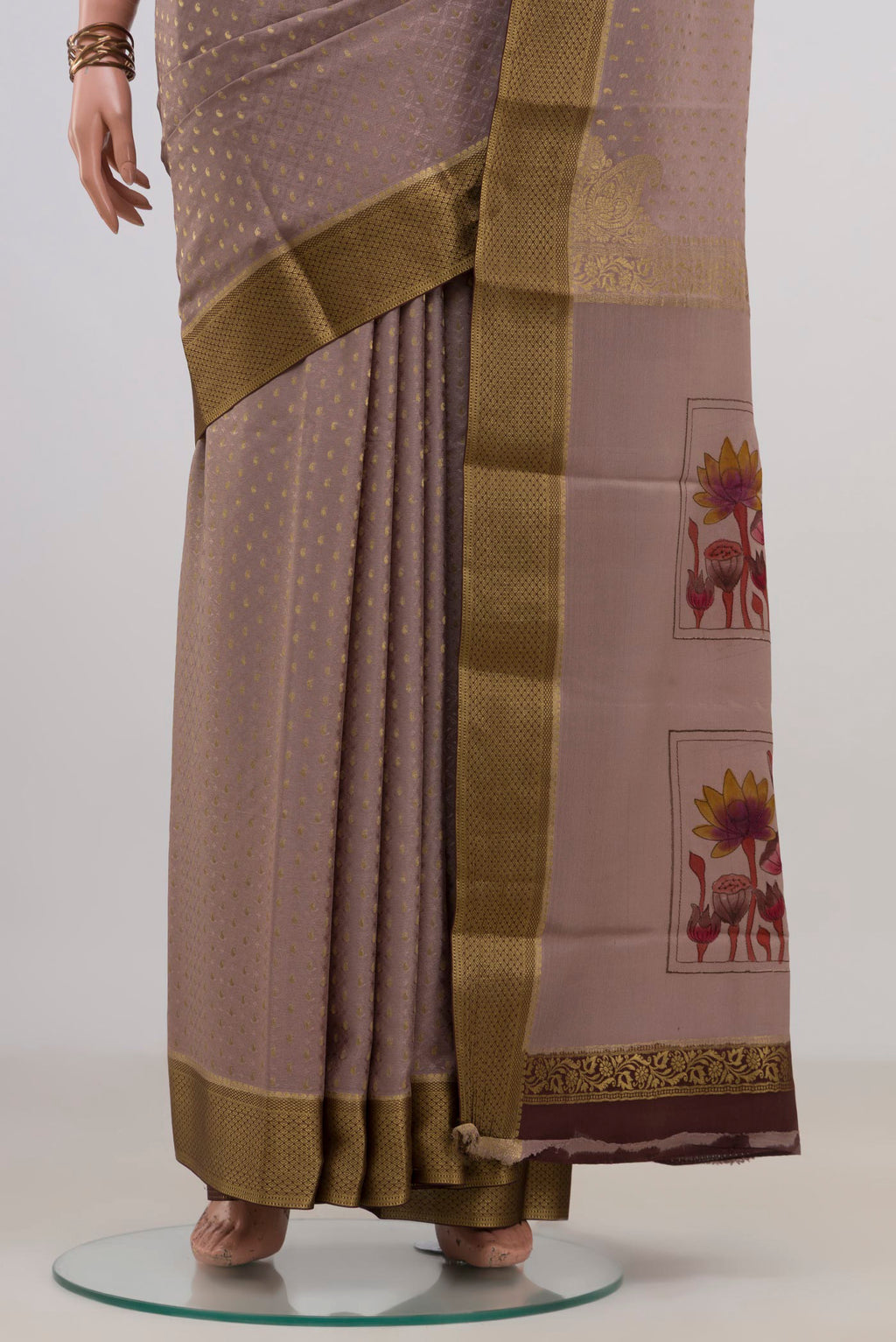 Pleats and pallu of Grey Crepe Saree with Fancy on the body and Zari Border. 