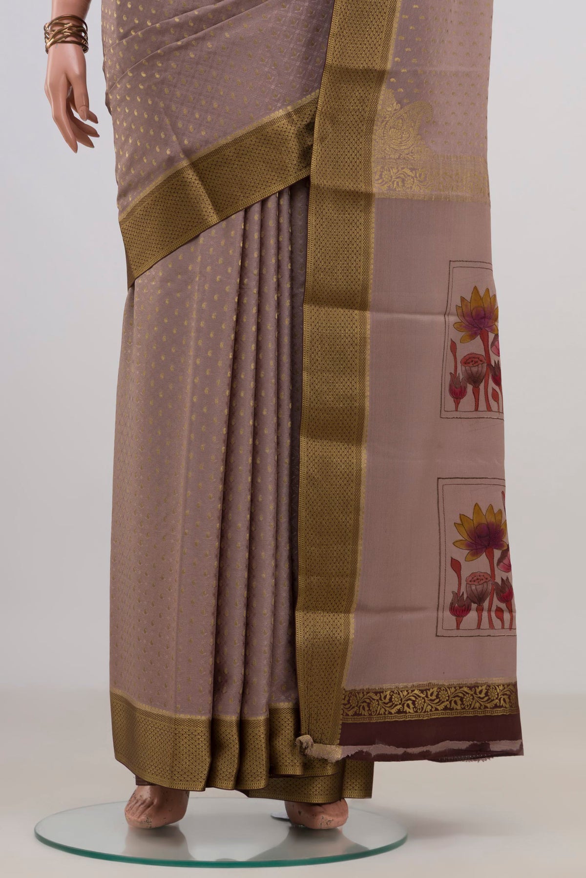 Pleats and pallu of Grey Crepe Saree with Fancy on the body and Zari Border. 