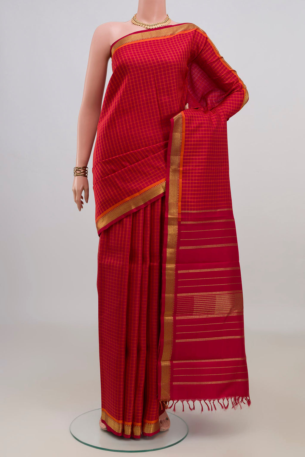 Pure Silk Pure Zari Red Kanchipuram Saree with Checked design on the body and Zari Border.  displayed on a mannequin