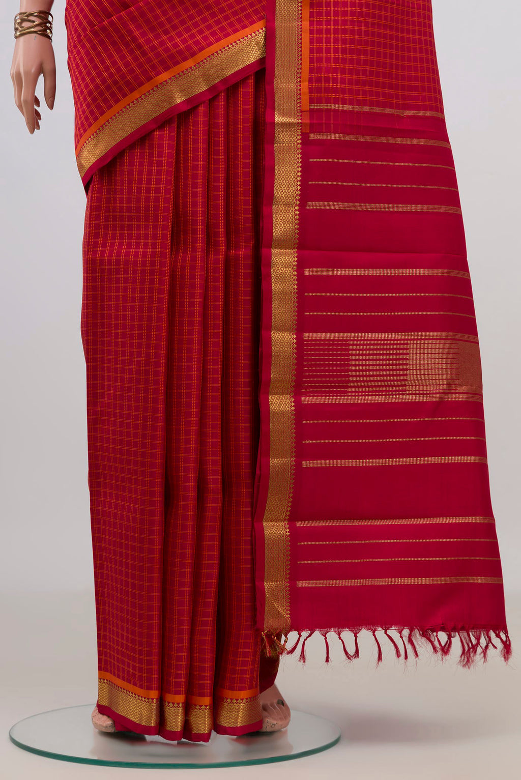 Pleats and pallu of Pure Silk Pure Zari Red Kanchipuram Saree with Checked design on the body and Zari Border. 