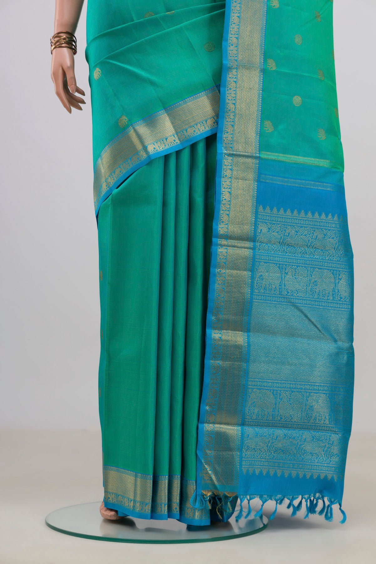 Pleats and pallu of Pure Silk Pure Zari Turquoise Kanjivaram Saree with Zari Butta on the body and Zari Border. 