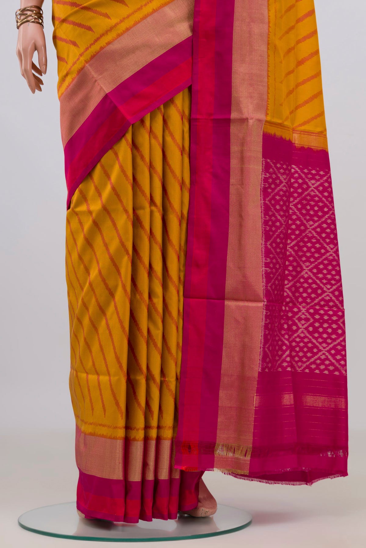 Pleats and pallu of Pure Silk Mustard Pochampally Saree with Pure Ikat on the body and Zari Border. 
