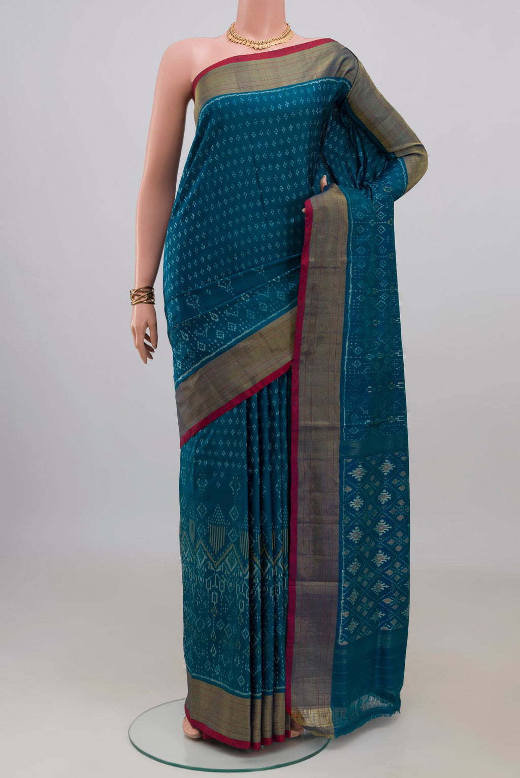 Pure Silk Peacock Blue Pochampally Saree with Pure Ikat on the body and Zari Border.  displayed on a mannequin
