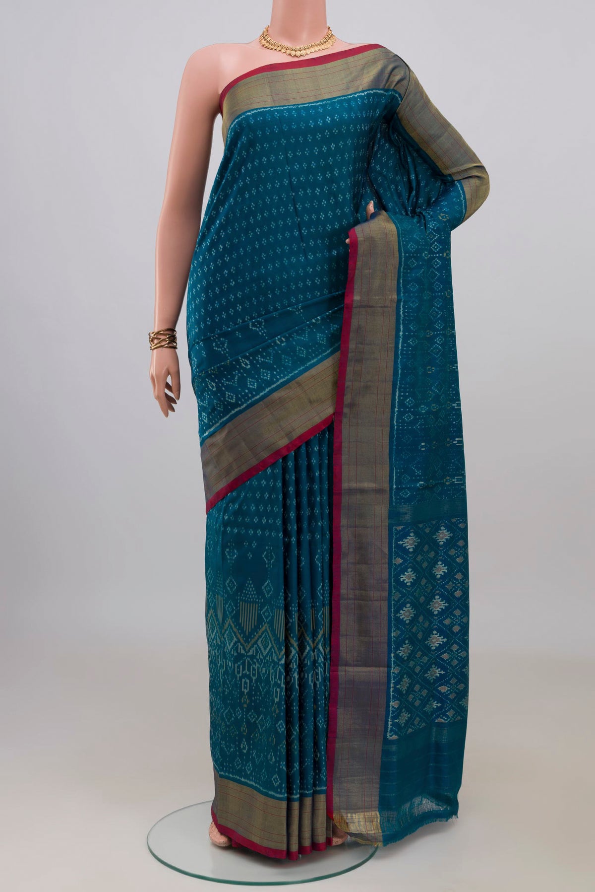 Pure Silk Peacock Blue Pochampally Saree with Pure Ikat on the body and Zari Border.  displayed on a mannequin