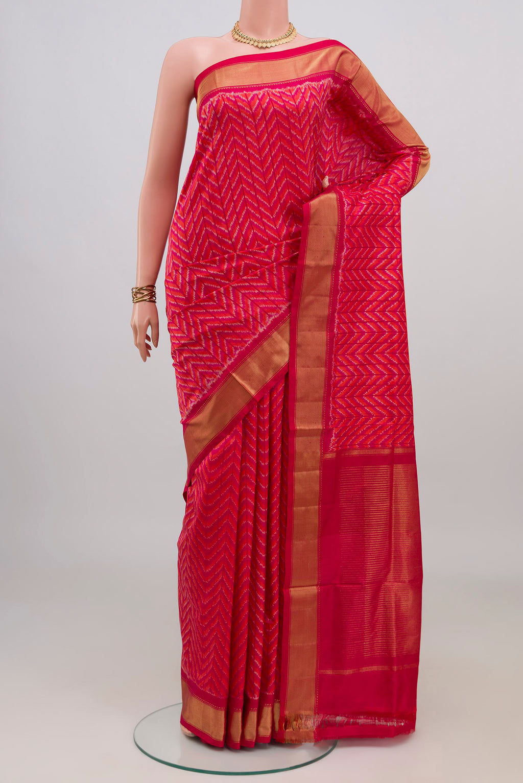 Pink Pochampally Silk Saree with Ikat design on the body and Zari Border.  displayed on a mannequin