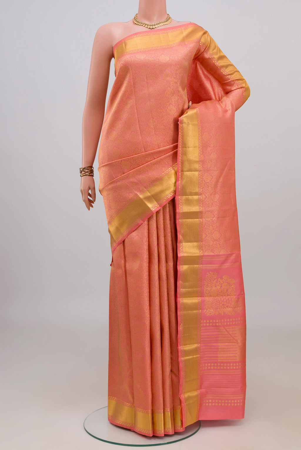 Pure Silk Coral Kanchipuram Saree with Zari Brocade on the body and Zari Border.  displayed on a mannequin