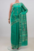 Pure Silk Green Baluchari Saree with Zari And Thread Butta on the body and Fancy Border.  displayed on a mannequin