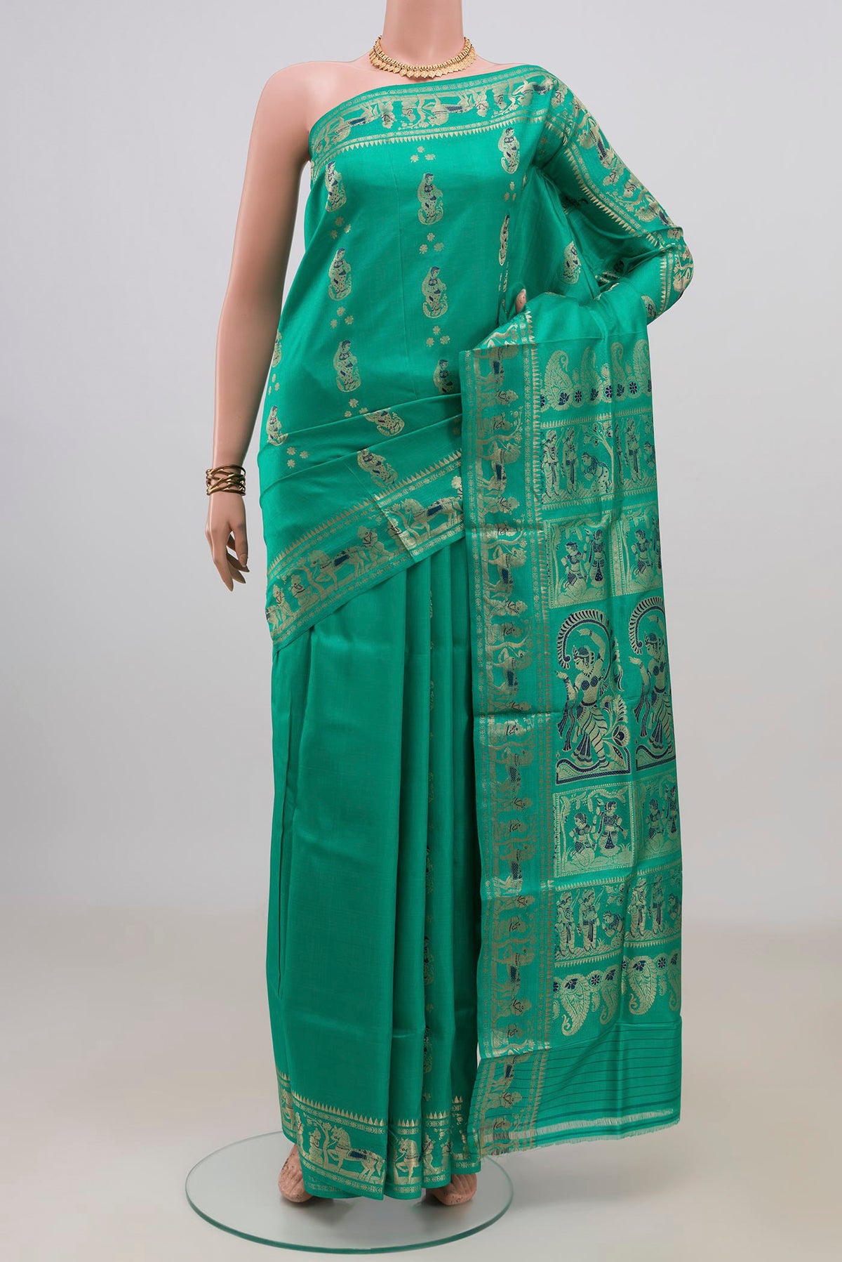 Pure Silk Green Baluchari Saree with Zari And Thread Butta on the body and Fancy Border.  displayed on a mannequin