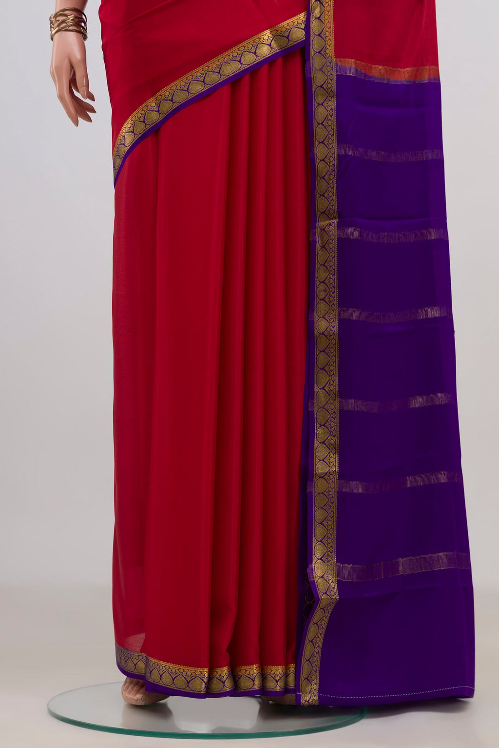 Pleats and pallu of Red Mysore Crepe Saree with Plain Body and Zari Border. 