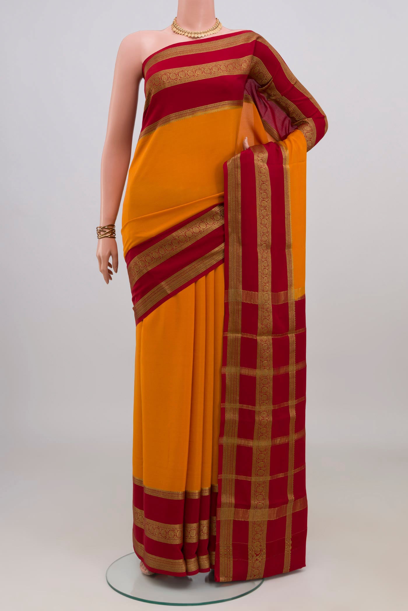 Yellow Mysore Crepe Saree with Plain Body and Zari Border.  displayed on a mannequin