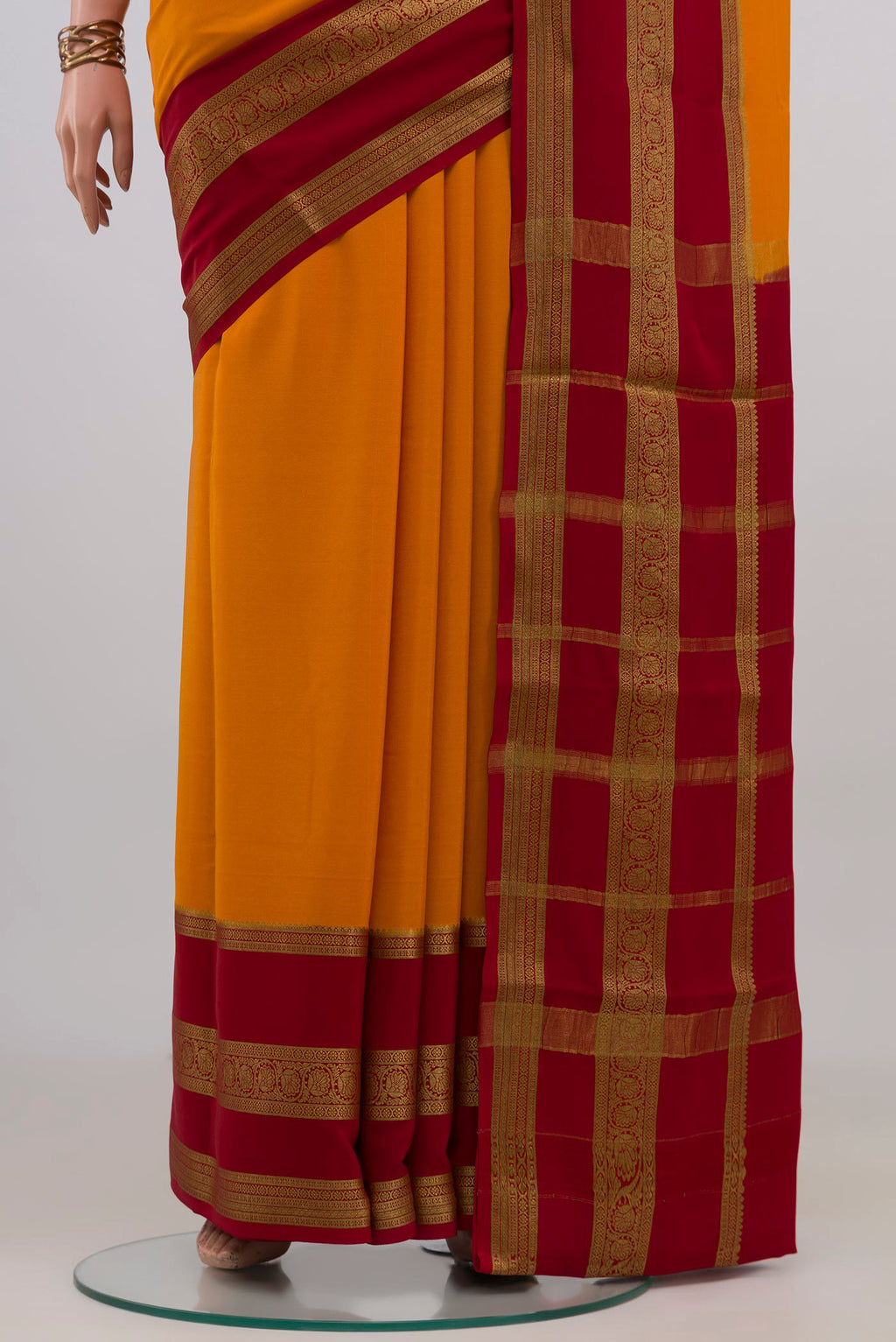 Pleats and pallu of Yellow Mysore Crepe Saree with Plain Body and Zari Border. 