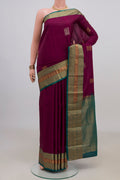 Pure Silk Purple Kanjivaram Saree with Zari Butta on the body and Zari Border.  displayed on a mannequin