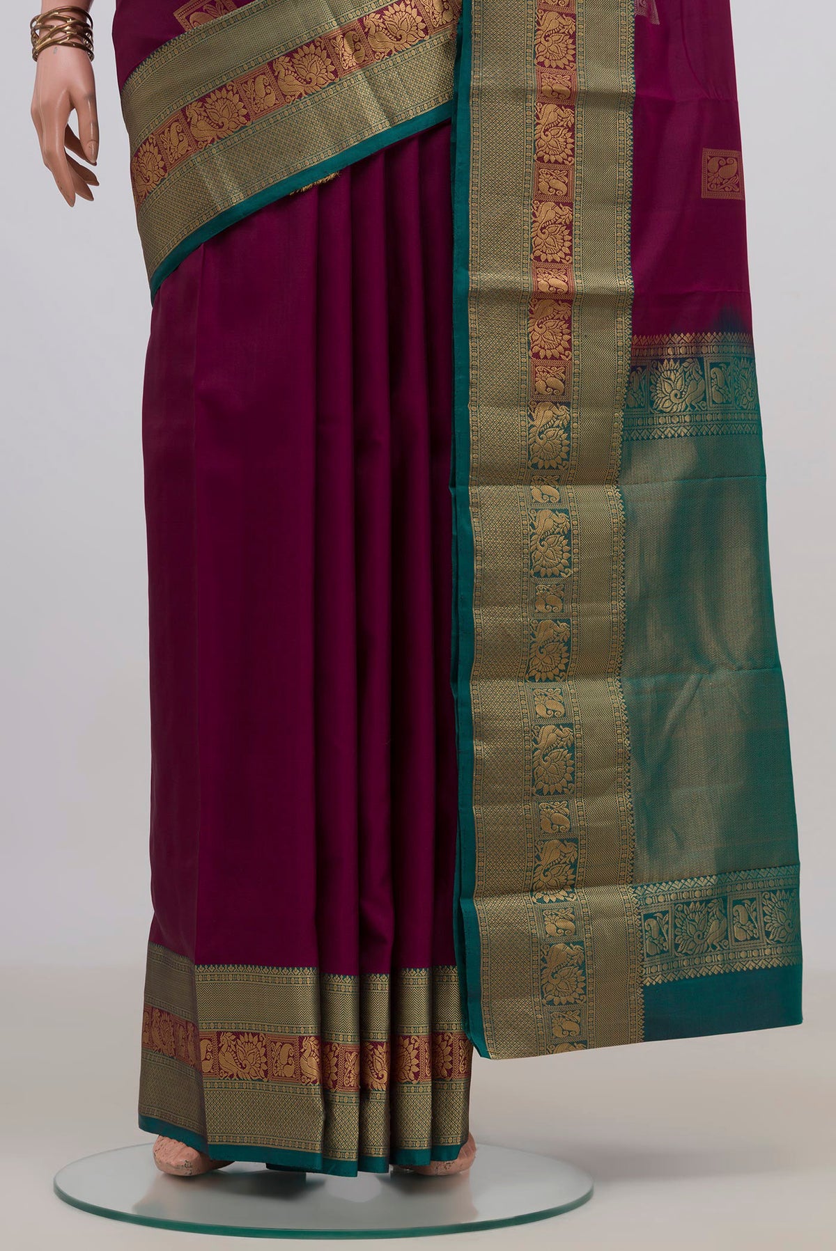 Pleats and pallu of Pure Silk Purple Kanjivaram Saree with Zari Butta on the body and Zari Border. 