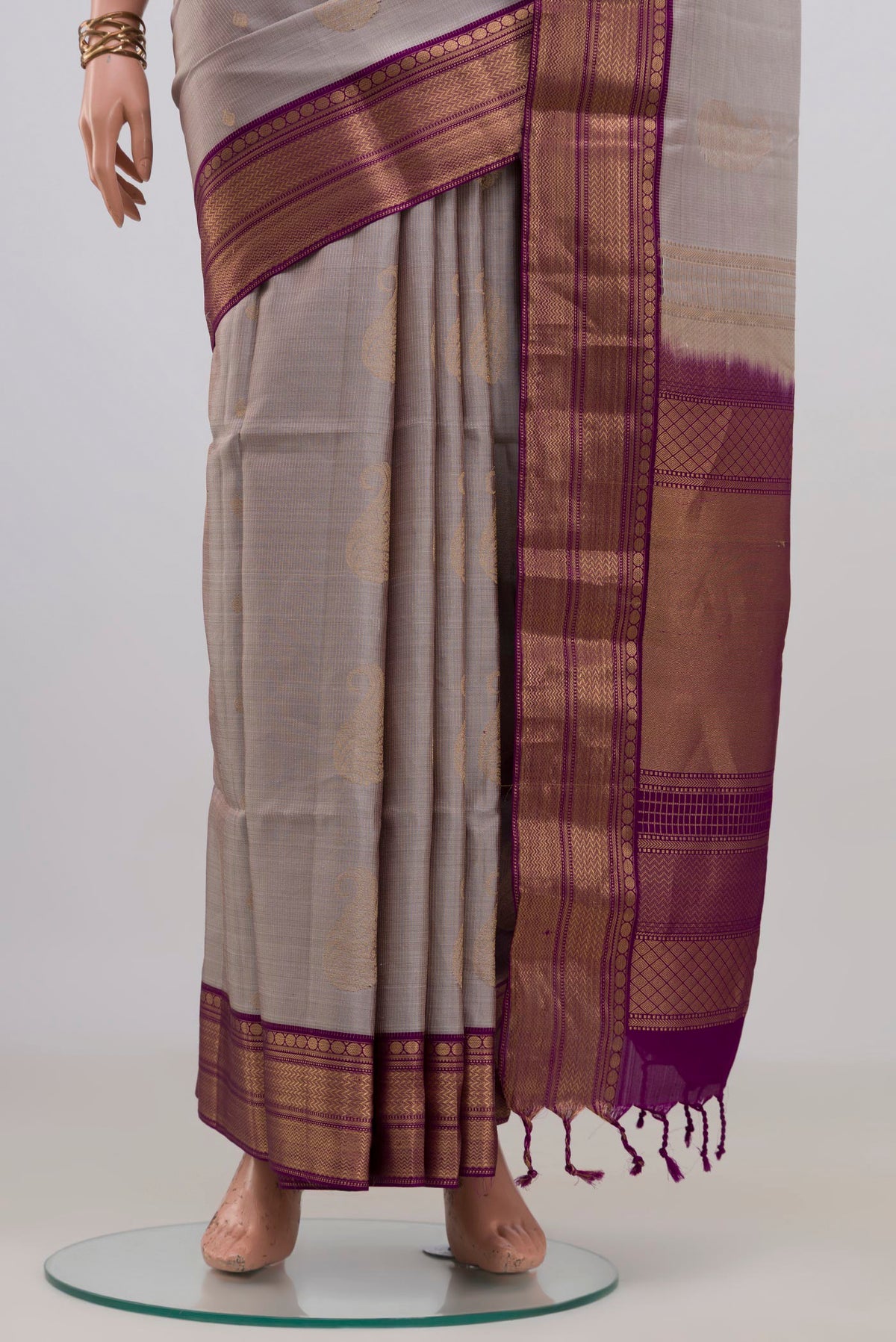 Pleats and pallu of Pure Silk Grey Soft Saree with Zari Butta on the body and Zari Border. 