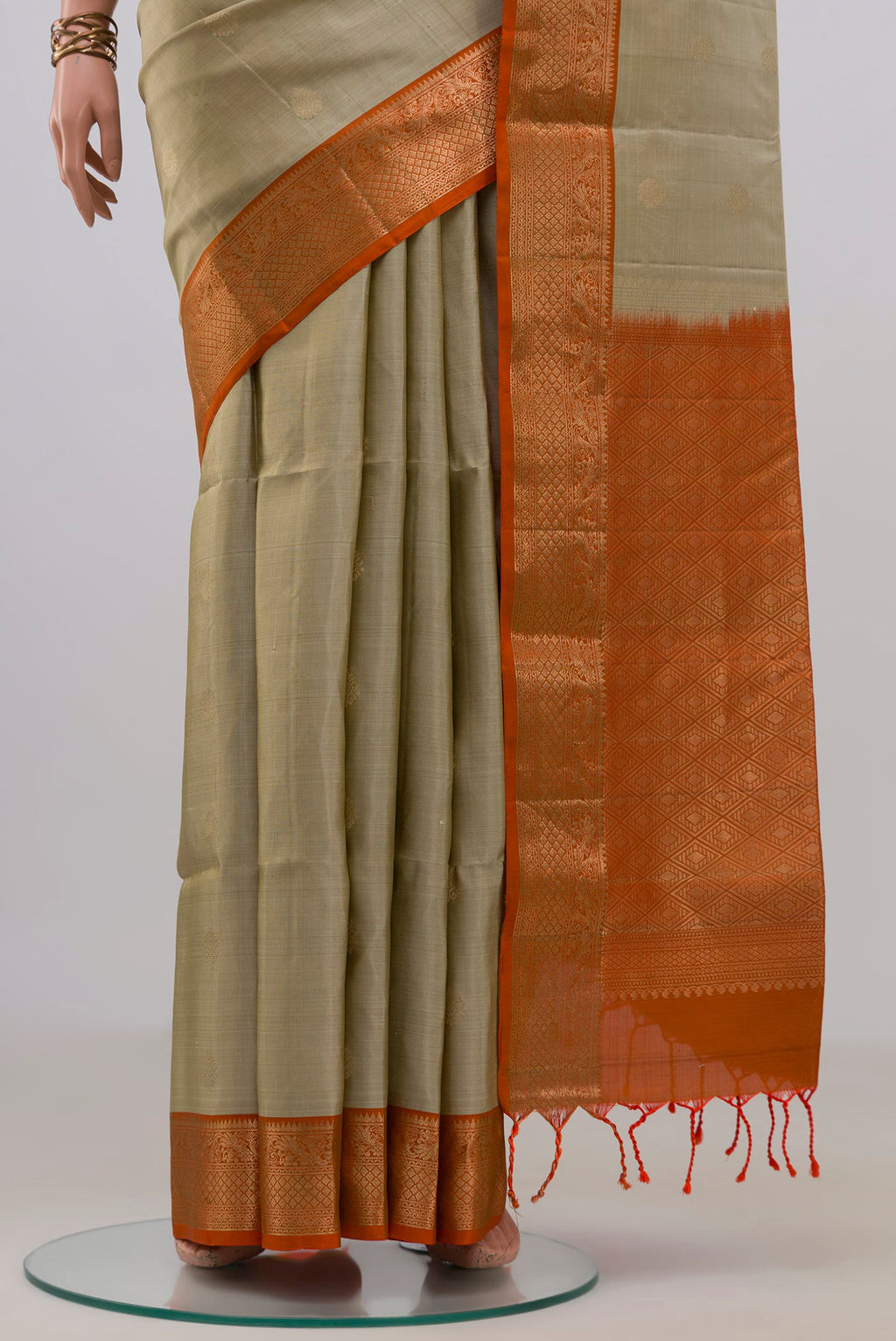 Pleats and pallu of Pure Silk Beige Soft Saree with Zari Butta on the body and Zari Border. 