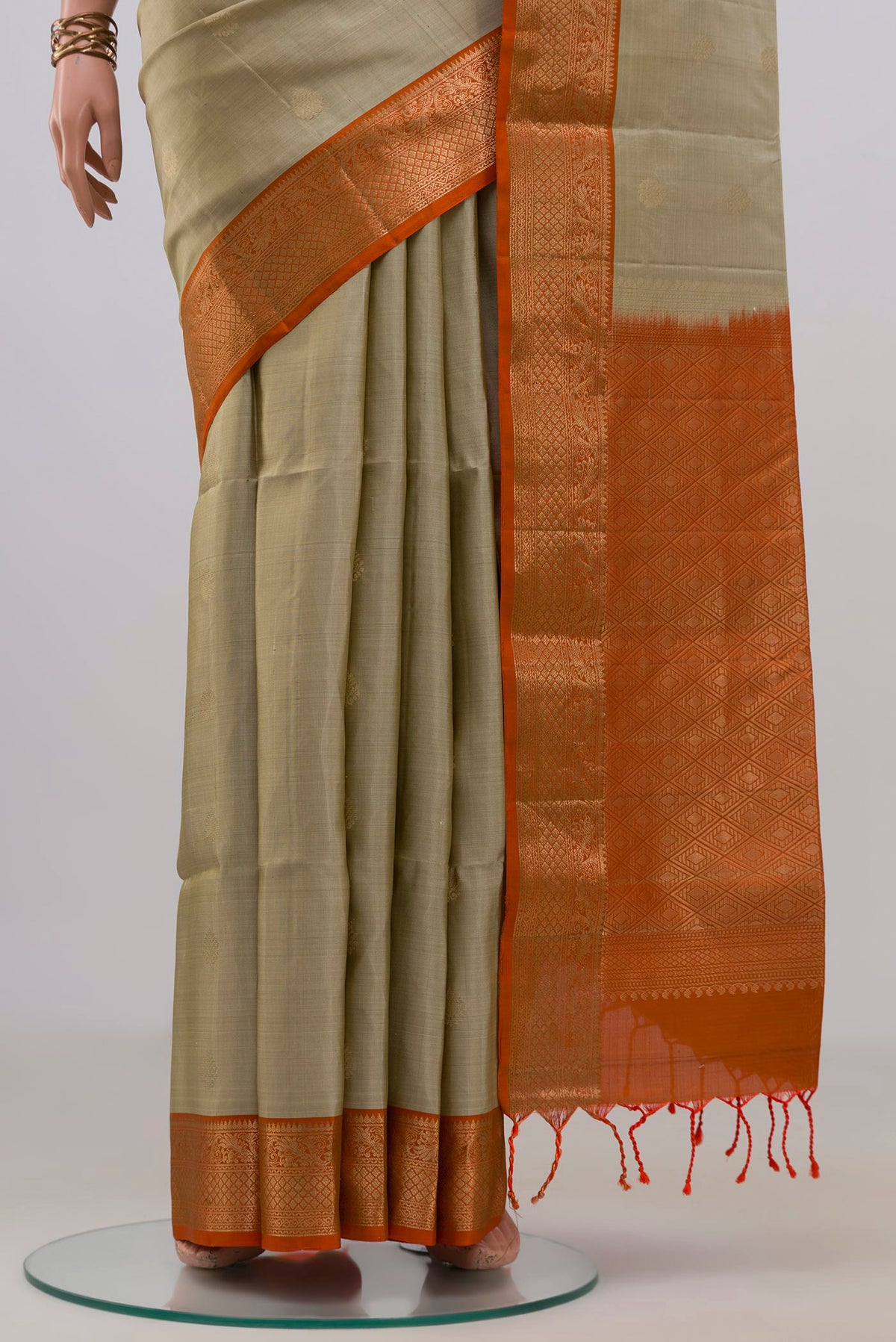 Pleats and pallu of Pure Silk Beige Soft Saree with Zari Butta on the body and Zari Border. 