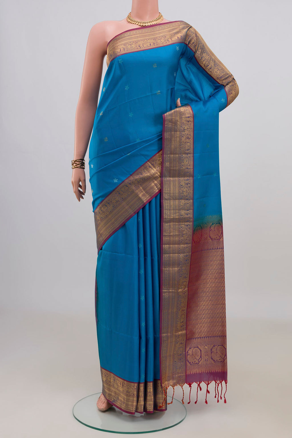 Pure Silk Blue Soft Saree with Zari Butta on the body and Zari Border.  displayed on a mannequin