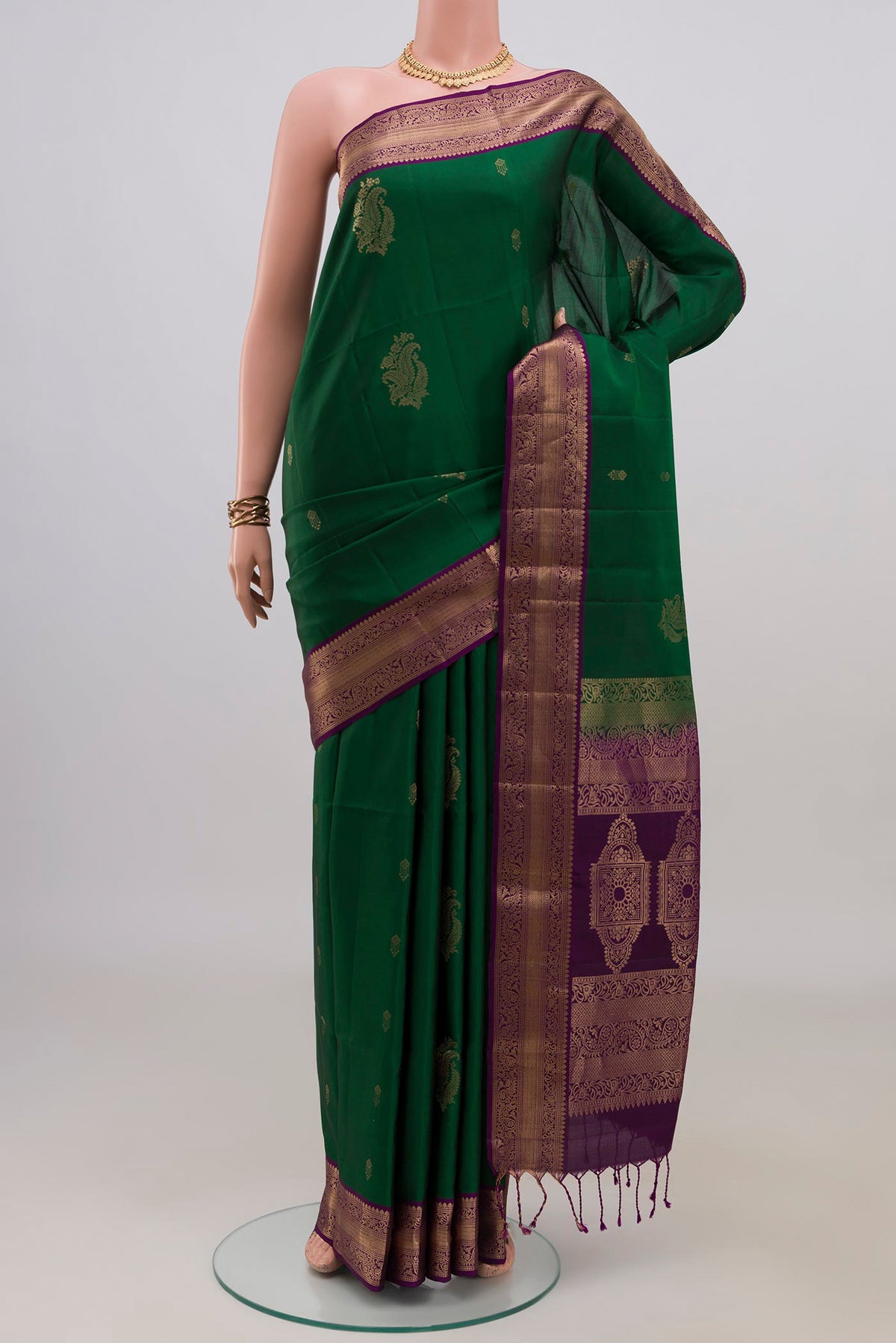 Pure Silk Green Soft Saree with Zari Butta on the body and Zari Border.  displayed on a mannequin