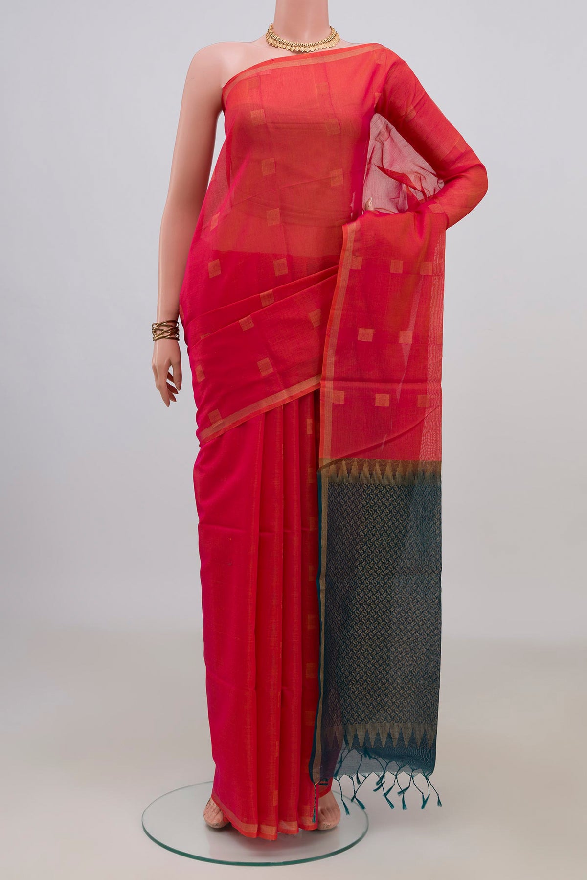 Coral Silk Cotton Saree with Zari Butta on the body and Thin Zari Line.  displayed on a mannequin