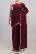 Pure Silk Maroon Kanjivaram Saree with Plain Body and Zari Border.  displayed on a mannequin