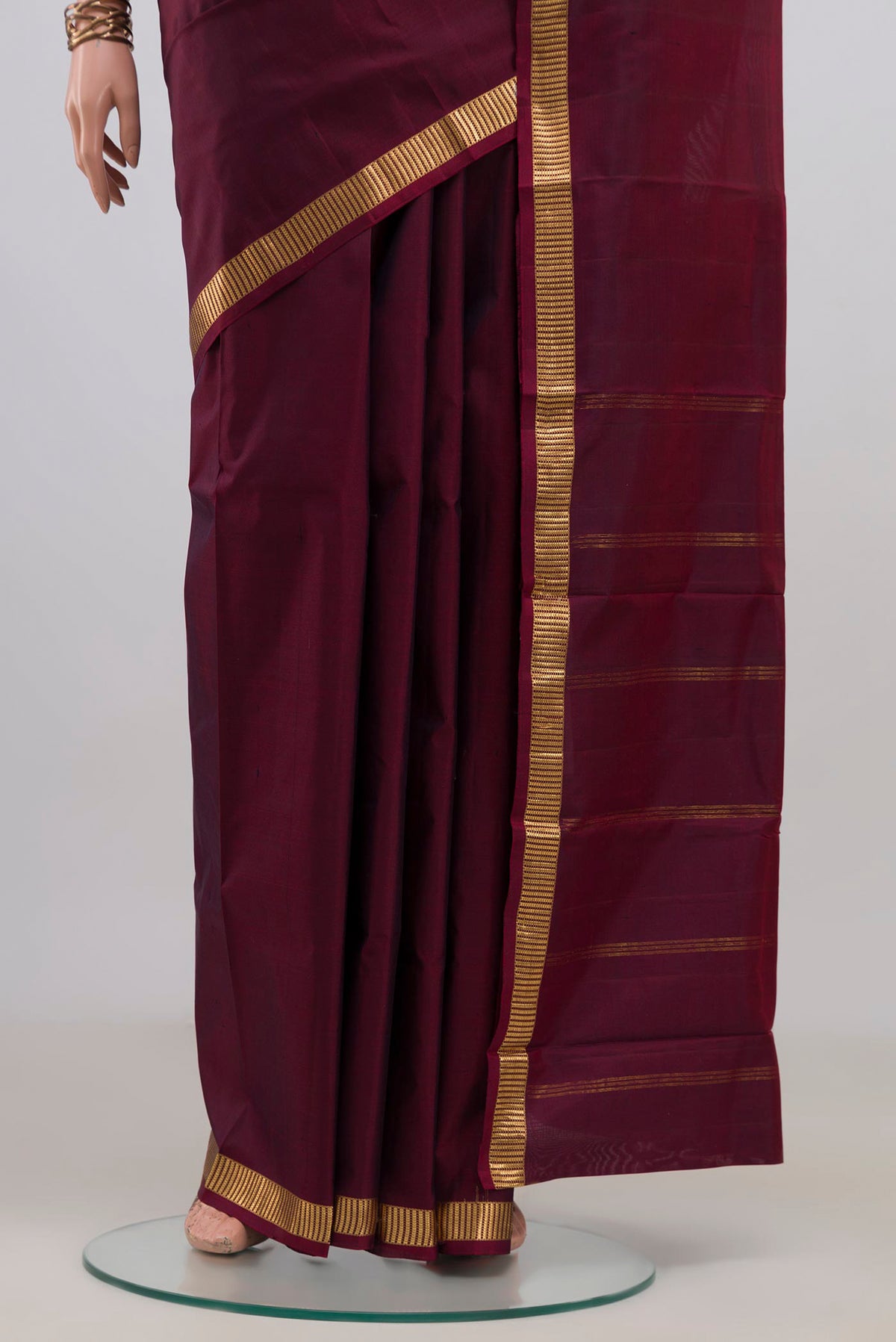 Pleats and pallu of Pure Silk Maroon Kanjivaram Saree with Plain Body and Zari Border. 