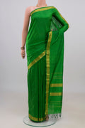 Pure Silk Green Kanjivaram Saree with Plain Body and Zari Border.  displayed on a mannequin