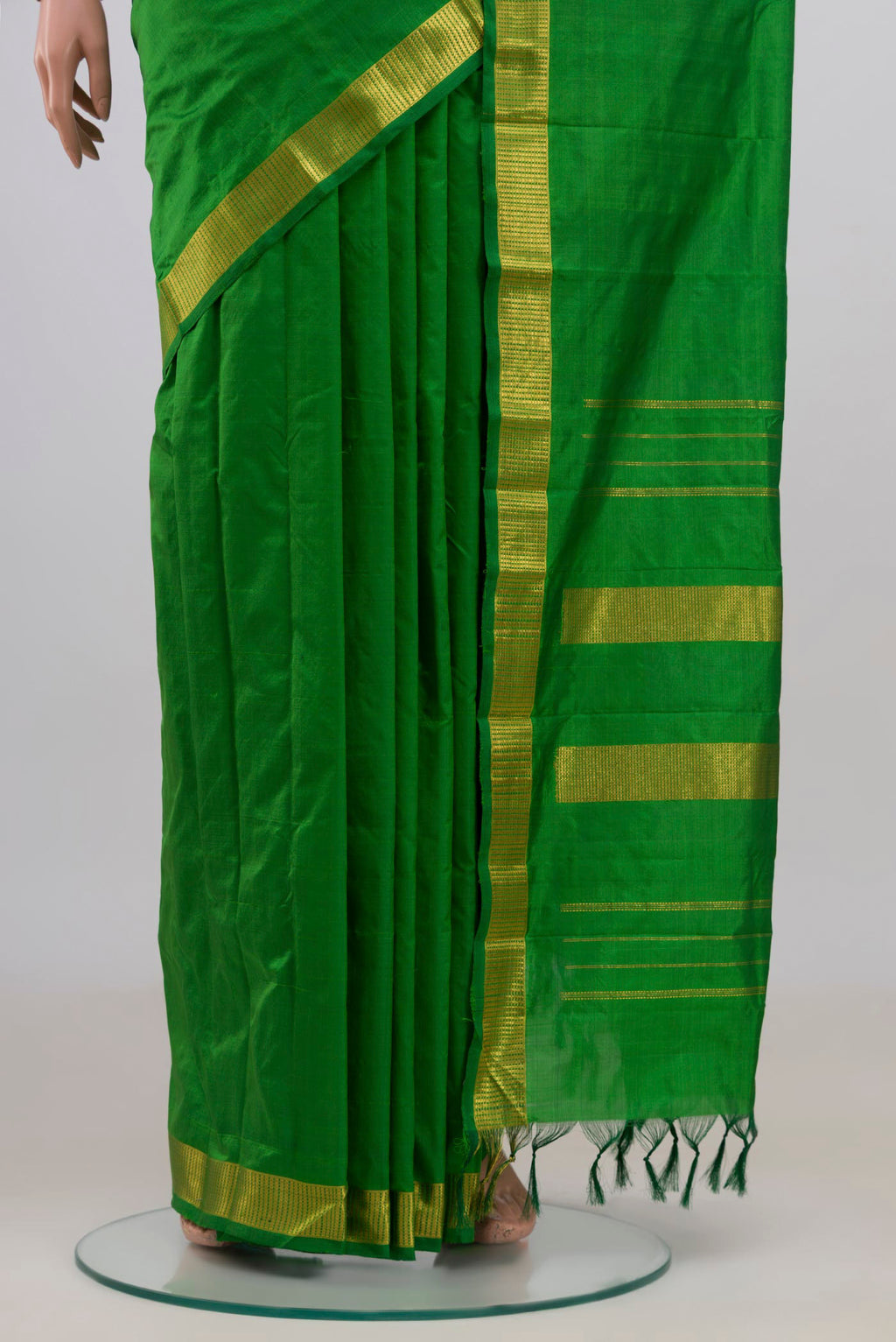 Pleats and pallu of Pure Silk Green Kanjivaram Saree with Plain Body and Zari Border. 