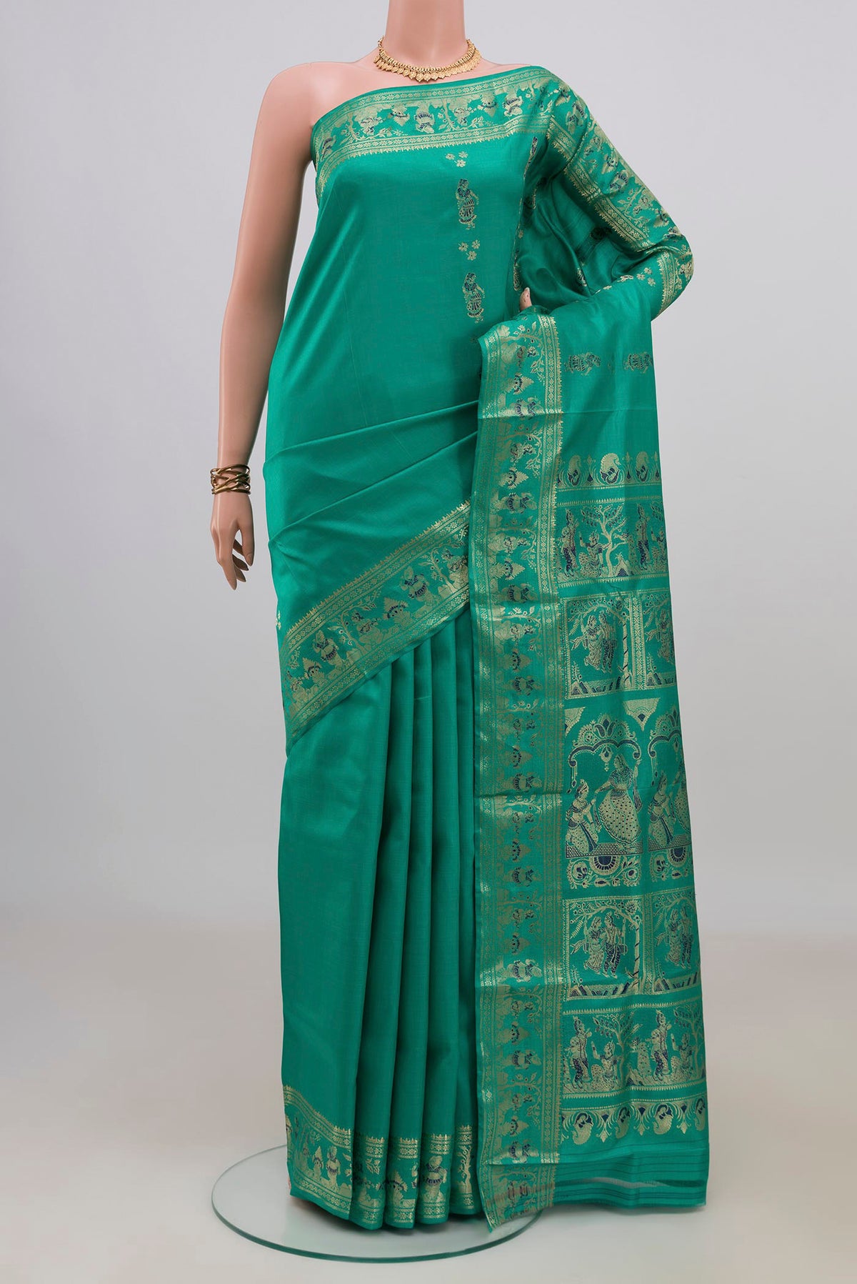 Pure Silk Green Baluchari Saree with Zari Butta on the body and Fancy Border.  displayed on a mannequin