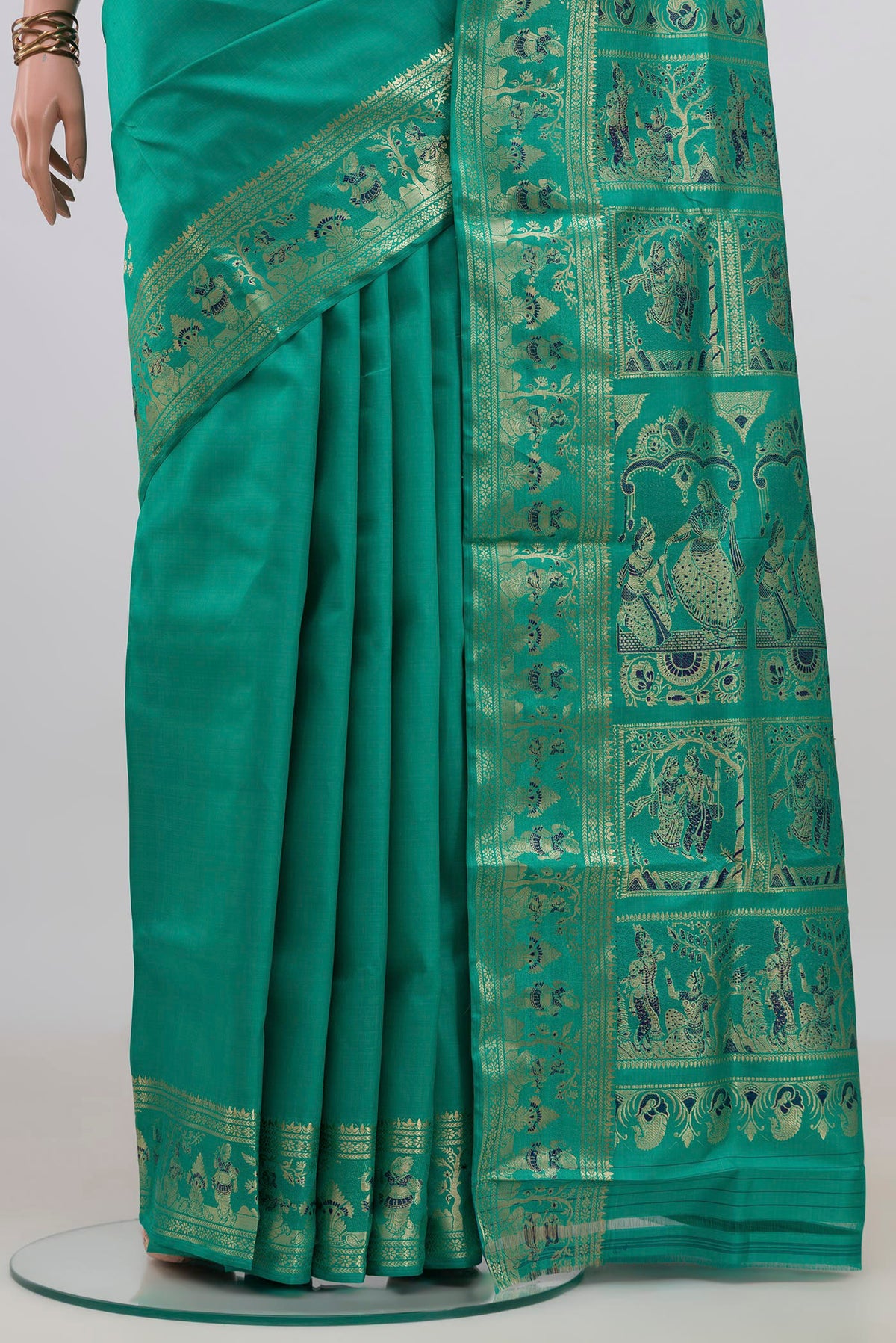 Pleats and pallu of Pure Silk Green Baluchari Saree with Zari Butta on the body and Fancy Border. 