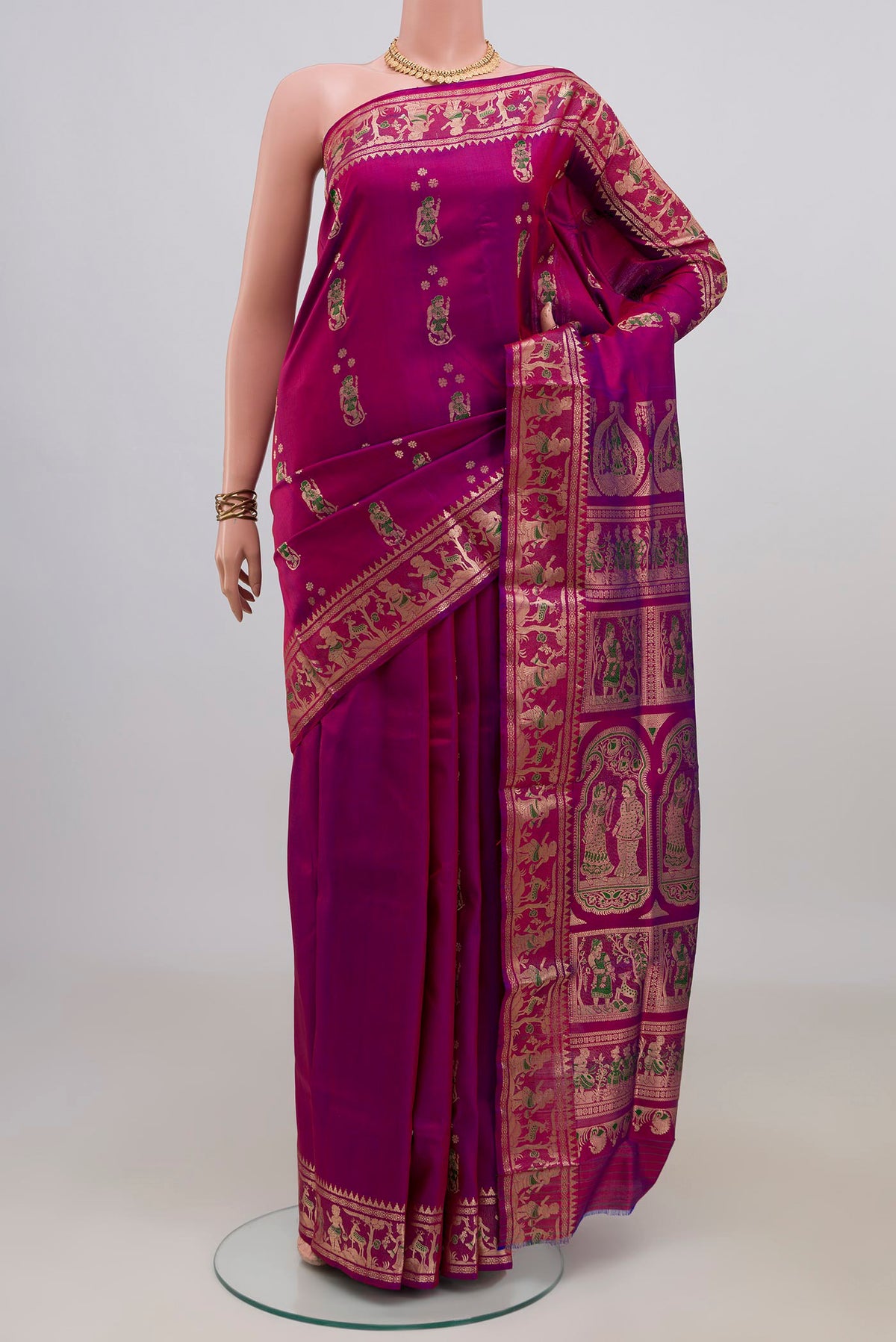 Pure Silk Magenta Baluchari Saree with Zari And Thread Butta on the body and Zari Border.  displayed on a mannequin