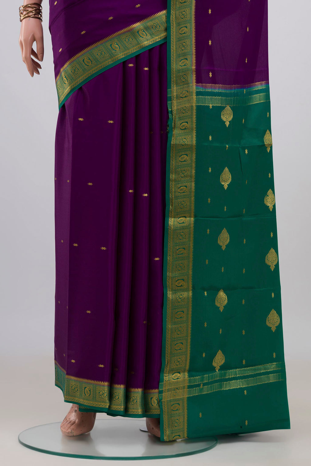 Pleats and pallu of Purple Mysore Crepe Saree with Zari Butta on the body and Zari Border. 