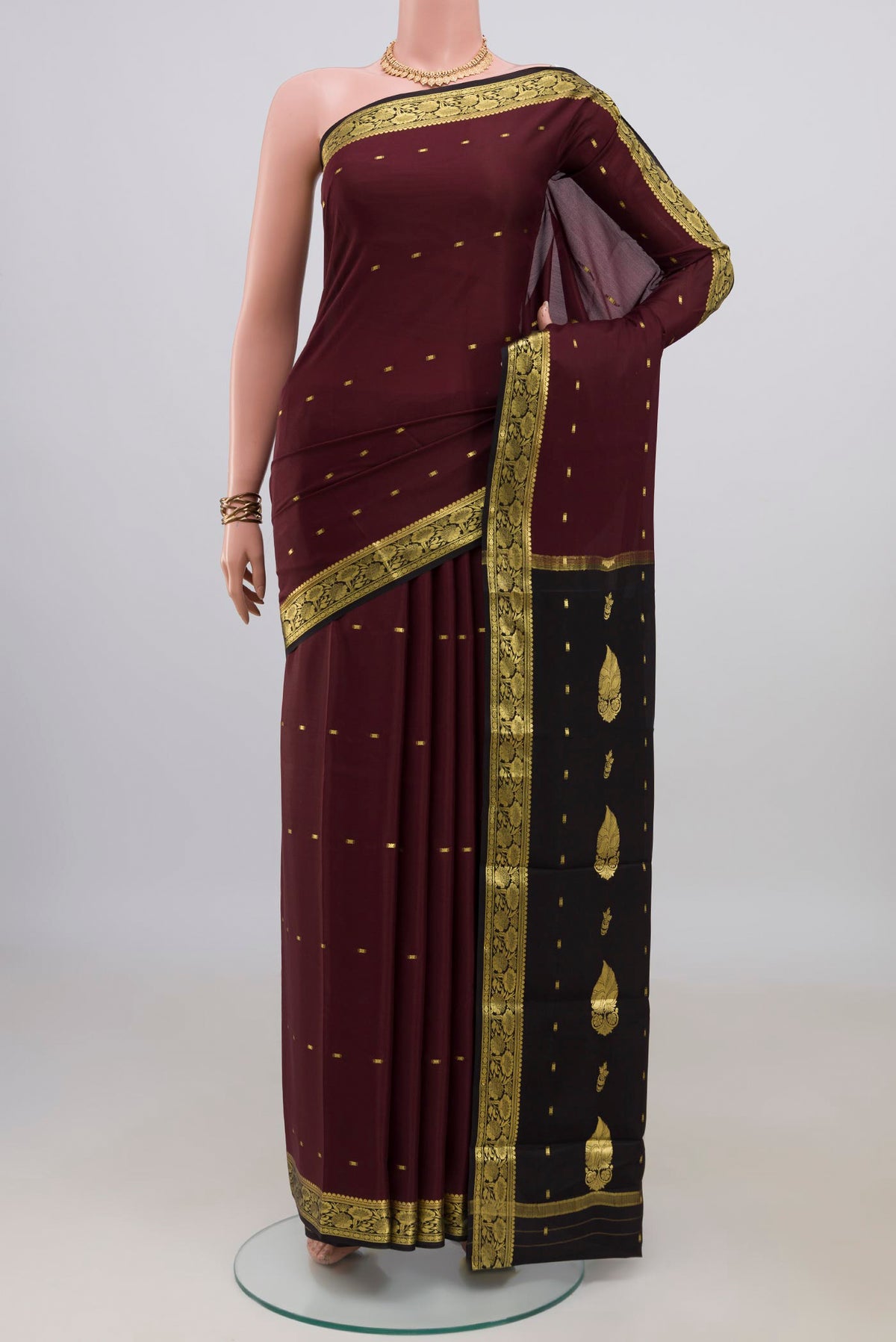 Brown Mysore Crepe Saree with Zari Butta on the body and Zari Border.  displayed on a mannequin
