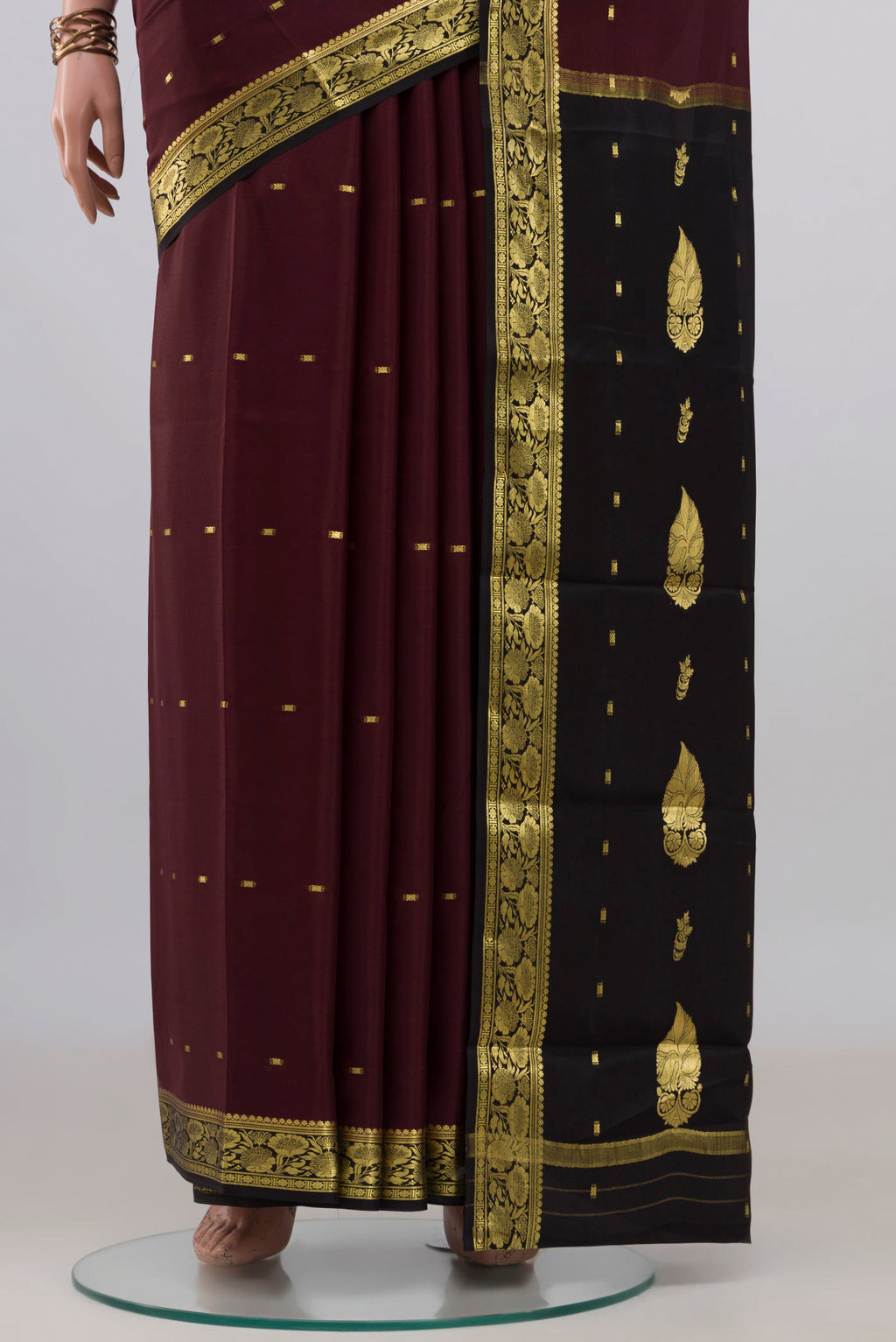 Pleats and pallu of Brown Mysore Crepe Saree with Zari Butta on the body and Zari Border. 