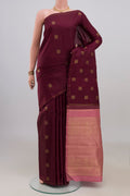 Pure Silk Pure Zari Maroon Kanchipuram Saree with Zari Butta on the body and Thin Zari Line.  displayed on a mannequin