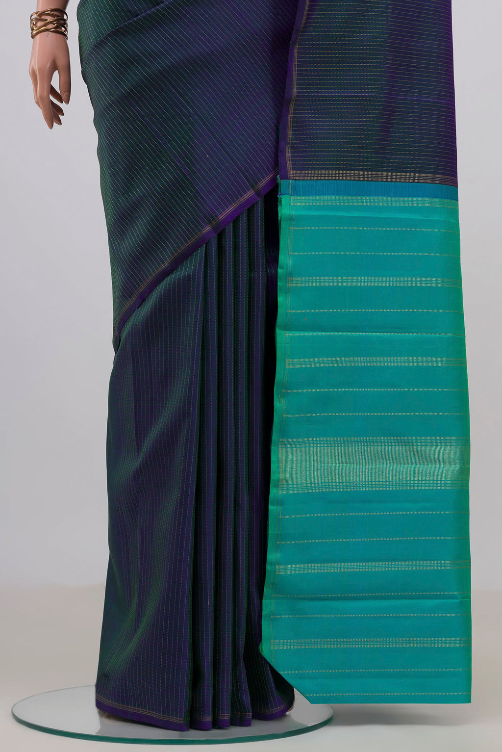 Pleats and pallu of Pure Silk Pure Zari Peacock Blue Dual Tone Kanjivaram Saree with Stripes on the body and Thin Zari Line. 