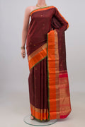 Pure Silk Maroon Kanchipuram Saree with Checked design on the body and Zari Border.  displayed on a mannequin