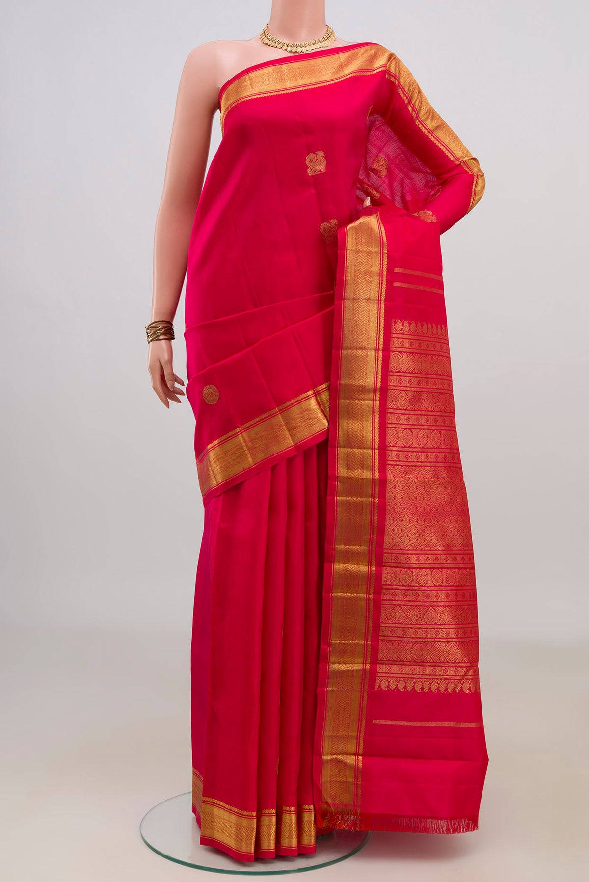 Pure Silk Pure Zari Red Kanchipuram Saree with Zari Butta on the body and Zari Border.  displayed on a mannequin