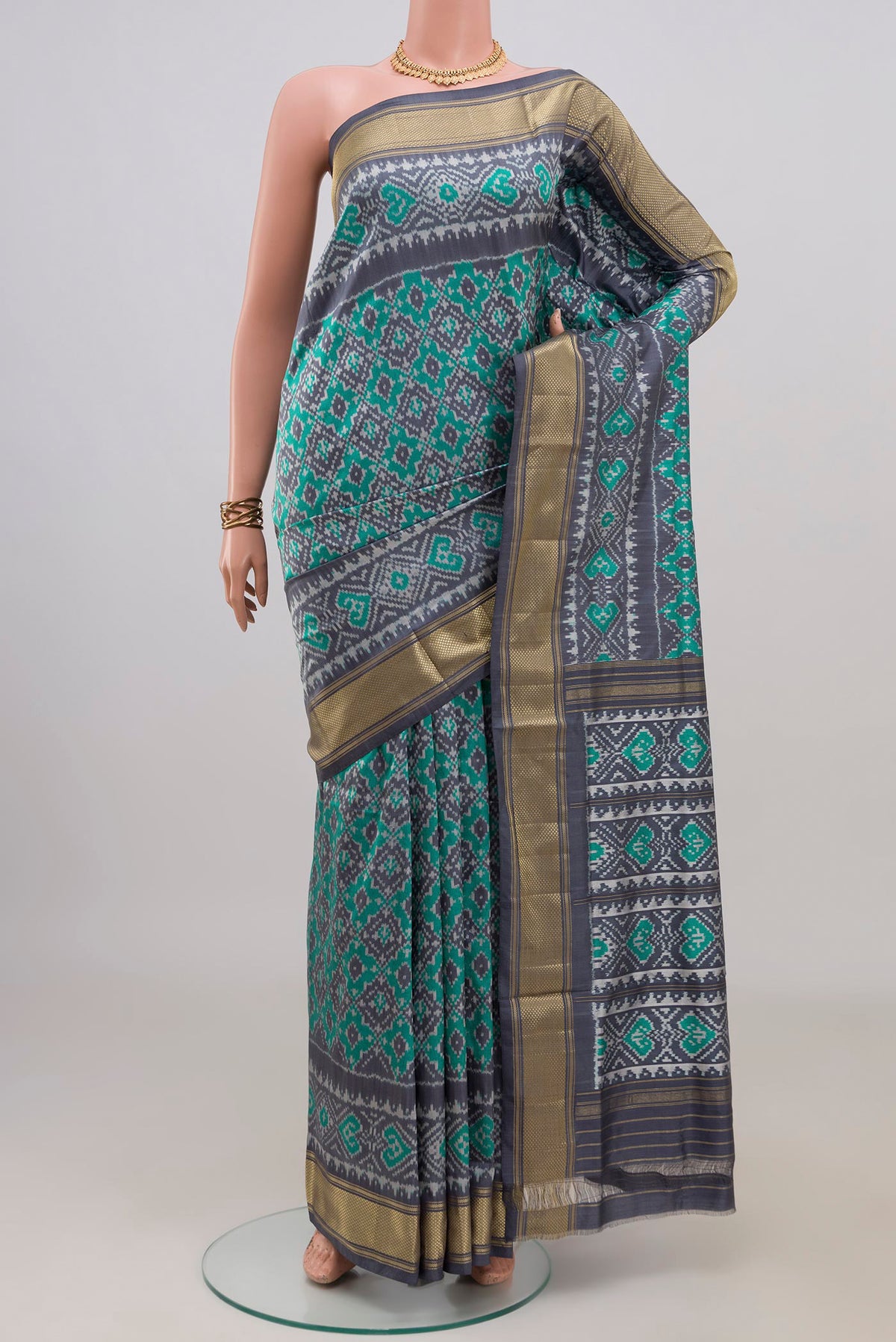 Pure Silk Sea Green Pochampally Saree with Pure Ikat on the body and Zari Border.  displayed on a mannequin