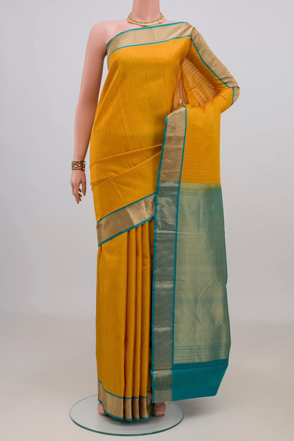 Pure Silk Yellow Kanchipuram Saree with Zari Butta on the body and Zari Border.  displayed on a mannequin