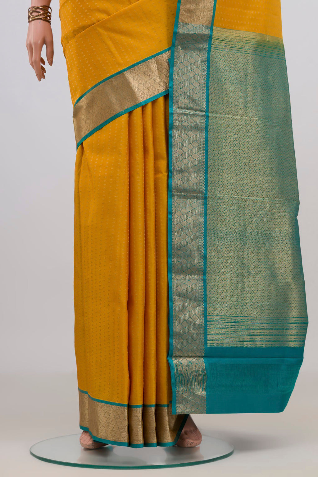 Pleats and pallu of Pure Silk Yellow Kanchipuram Saree with Zari Butta on the body and Zari Border. 