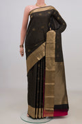 Pure Silk Black Kanchipuram Saree with Zari Butta on the body and Zari Border.  displayed on a mannequin
