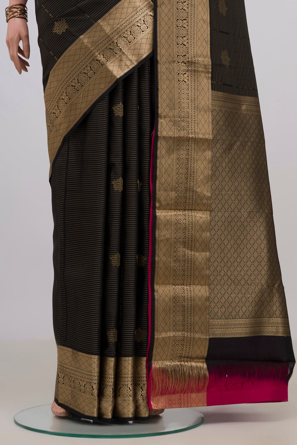 Pleats and pallu of Pure Silk Black Kanchipuram Saree with Zari Butta on the body and Zari Border. 