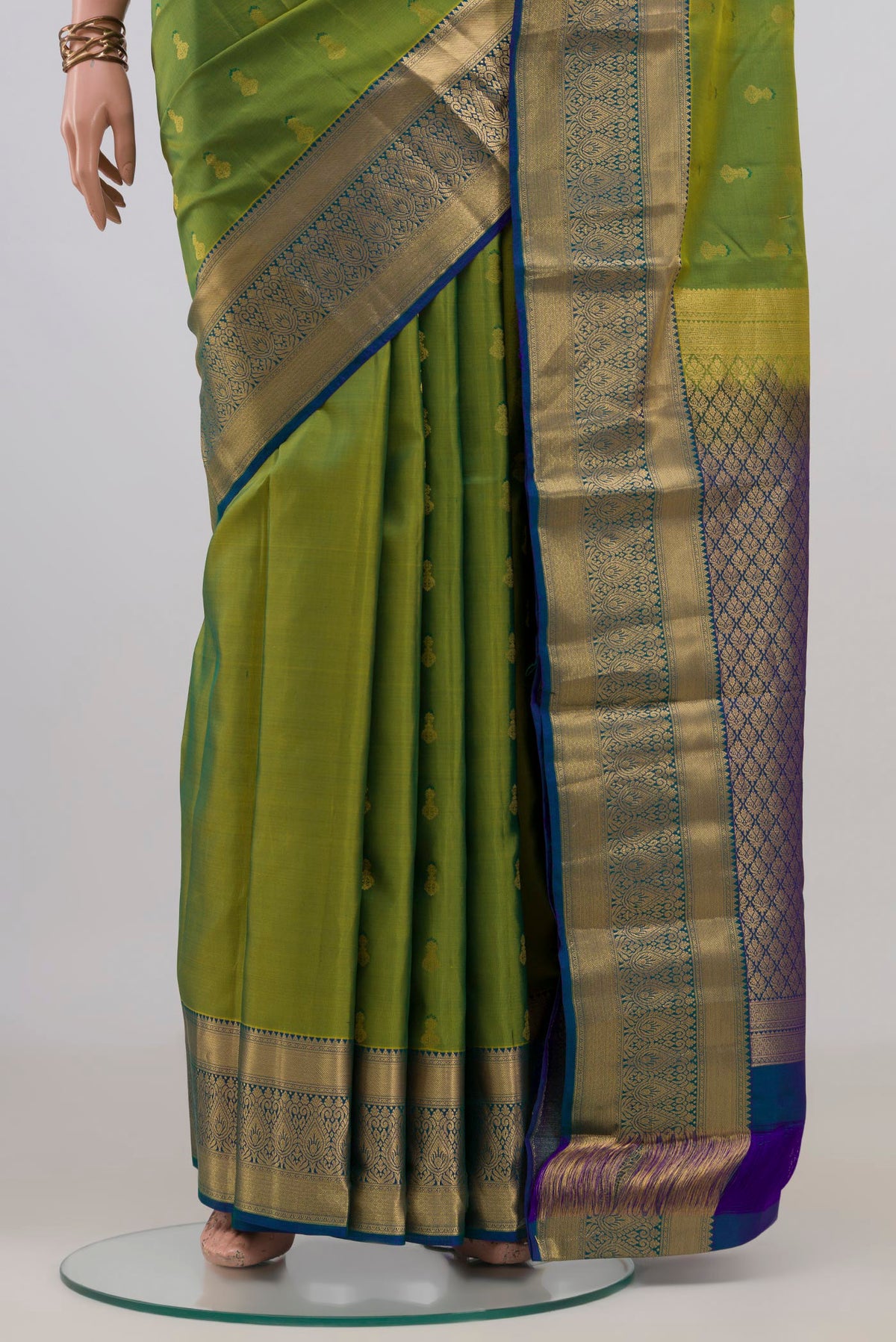 Pleats and pallu of Pure Silk Green Kanchipuram Saree with Zari Butta on the body and Zari Border. 